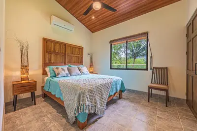 a bedroom with a bed and a window at Villa Tortuga- 3 Minute Walk to the Beach in Savegre