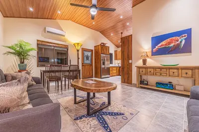 a living room with a couch and a table at Villa Tortuga- 3 Minute Walk to the Beach in Savegre