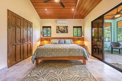 a bedroom with a large bed in a room at Villa Tortuga- 3 Minute Walk to the Beach in Savegre