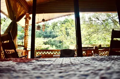 a room with a table and chairs and a large window at Cabaña Colibrí - Parking in Sarchí
