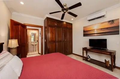 a bedroom with a bed and a ceiling fan at Playa Flamingo Ocean View Retreat in Playa Flamingo