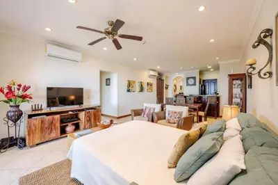 a large living room with a couch and a tv at Playa Flamingo Ocean View Retreat in Playa Flamingo