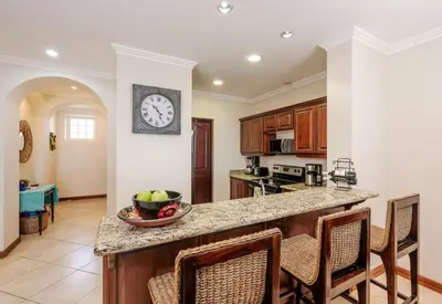 a kitchen with a counter and a clock on the wall at Playa Flamingo Ocean View Retreat in Playa Flamingo