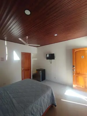 a bedroom with a bed and a wooden ceiling at Las Morenas in Nosara