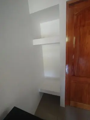 a corner of a room with a wooden cabinet at Las Morenas in Nosara