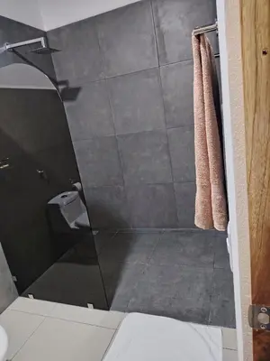 a bathroom with a shower with a glass door at Las Morenas in Nosara