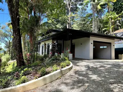 a house with a garage in front of it at Majestic View House in Dominical, Oceanview in San Luis