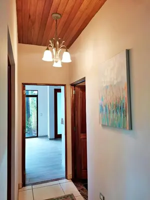 a hallway in a house with a painting on the wall at Majestic View House in Dominical, Oceanview in San Luis