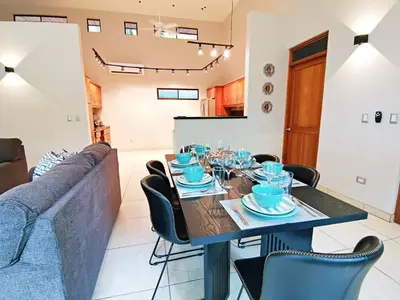 a dining room with a table and a couch at Majestic View House in Dominical, Oceanview in San Luis