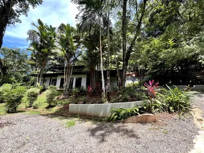 a house with trees and plants in a yard at Majestic View House in Dominical, Oceanview in San Luis