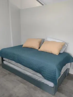 a bed with two pillows on top of it at Marea Place in Carrillo