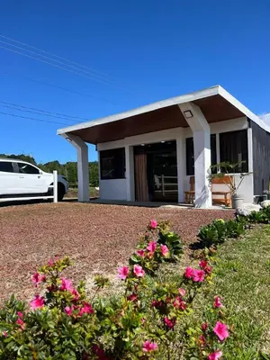 a house with pink flowers in front of it at Green haven in Alajuela City