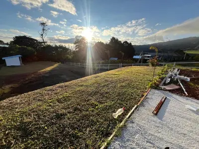a view of a field with the sun in the sky at Green haven in Alajuela City