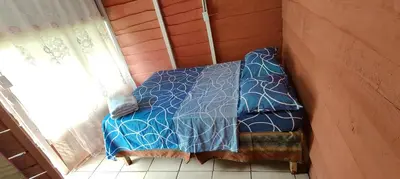 a bed in a corner of a room with a window at Millar de Aves in Empalme