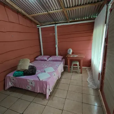 a small room with two beds and a table at Millar de Aves in Empalme