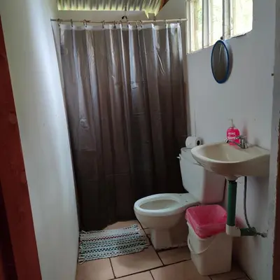 a bathroom with a shower and a toilet and a sink at Millar de Aves in Empalme
