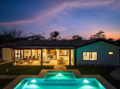 a house with a swimming pool at night at Casa Samay in Playa Avellana