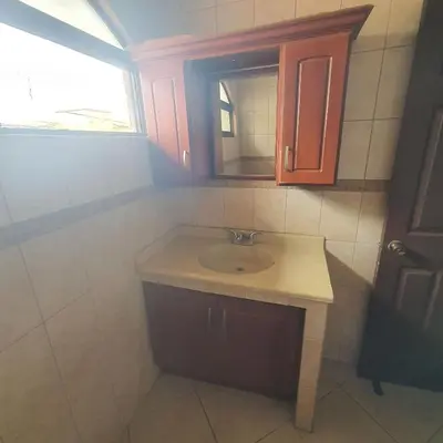a bathroom with a sink and a mirror at Rooms For RENT, Roommates, Or As BB in Heredia