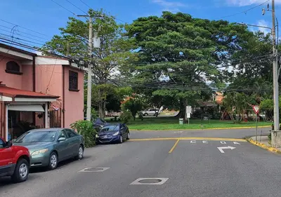 two cars parked on the side of a street at Rooms For RENT, Roommates, Or As BB in Heredia