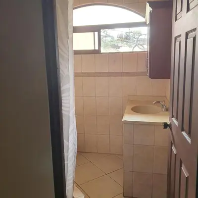 a bathroom with a sink and a window at Rooms For RENT, Roommates, Or As BB in Heredia