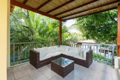 a porch with a couch and a glass table at Appartamento Oasis Azul in Potrero
