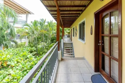 a balcony of a house with a wooden door at Appartamento Oasis Azul in Potrero