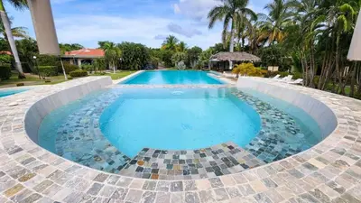 a large swimming pool with a tiled floor at Appartamento Oasis Azul in Potrero