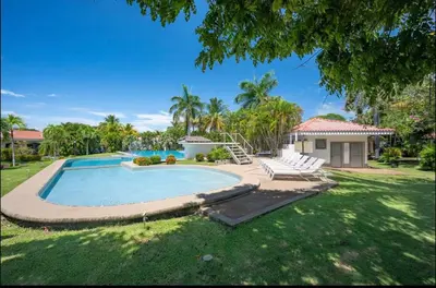 a yard with a swimming pool and a house at Appartamento Oasis Azul in Potrero