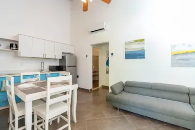 a kitchen and a living room with a couch and a table at Appartamento Oasis Azul in Potrero