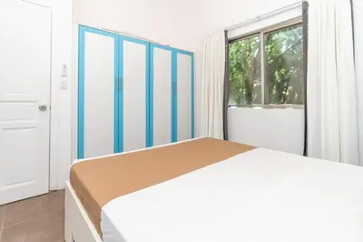 a white bedroom with a bed and a window at Appartamento Oasis Azul in Potrero