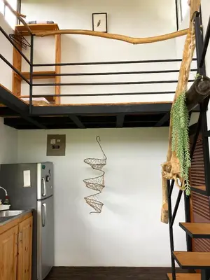 a spiral staircase in a kitchen with a loft at Casas Kawö y Tulu