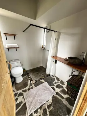 a bathroom with a toilet in a room at Casas Kawö y Tulu