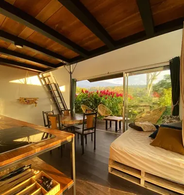 a bedroom with a bed and a table and chairs at Casas Kawö y Tulu