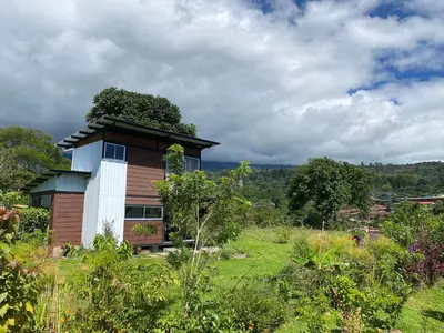 a house with a green roof on top of a field at Casas Kawö y Tulu