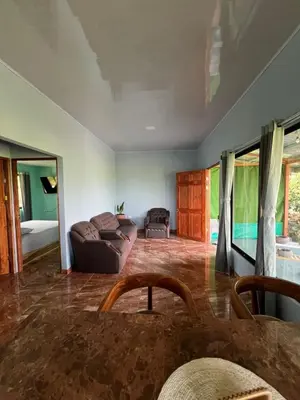a living room with a couch and a table at La Casa Tropical in Guayabal