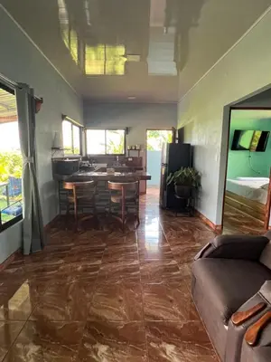 a living room with a couch and a table at La Casa Tropical in Guayabal