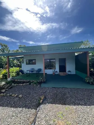a small house with a green roof at La Casa Tropical in Guayabal