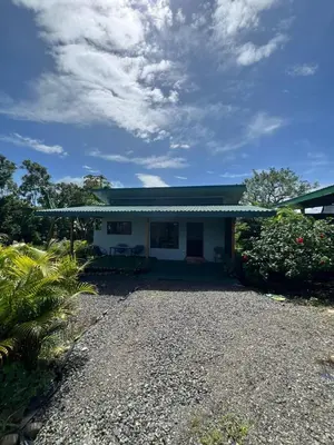 a house with a gravel driveway in front of it at La Casa Tropical in Guayabal