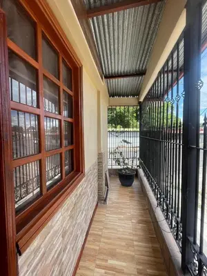 a hallway with a balcony with windows and a porch sidx sidx at Cabinas en Cañas Guanacaste in Cañas