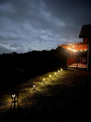 a group of lights in front of a building at night at Cabaña el mirador in Empalme