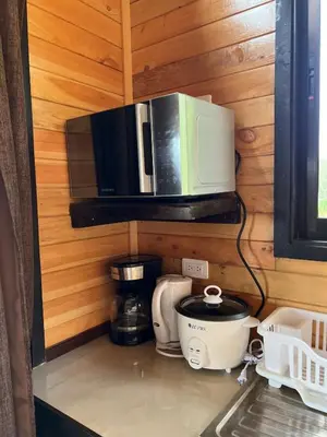 a kitchen with a microwave and a coffee maker at Cabaña el mirador in Empalme