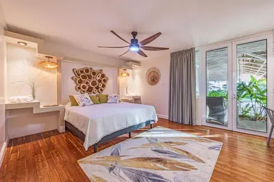 a bedroom with a bed and a ceiling fan at Casa Colinas Pickleball in Playa Grande