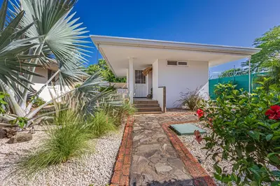 a house with a pathway leading to the front of it at Casa Colinas Pickleball in Playa Grande