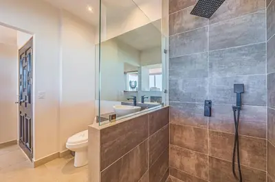a bathroom with a shower and a toilet and a sink at Casa Colinas Pickleball in Playa Grande