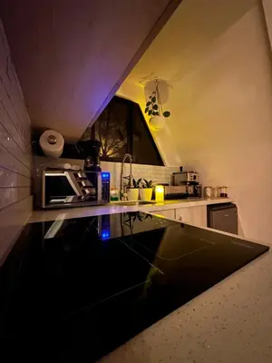 a small kitchen with a black counter top at Casa Jardin BV