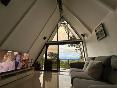 a living room with a large window and a couch at Casa Jardin BV