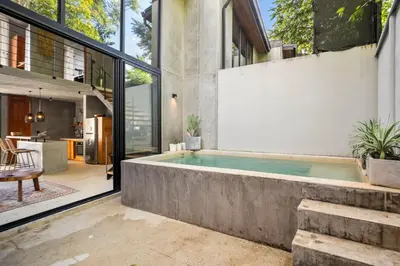 an indoor swimming pool in the middle of a house at TL1 Bright Stylish Loft with Green Views in Tamarindo