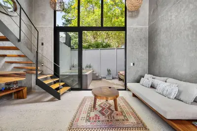 a living room with a couch and a table at TL1 Bright Stylish Loft with Green Views in Tamarindo
