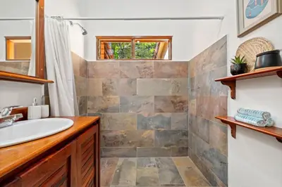 a bathroom with a sink and a mirror at PdM6 Newly Renovated Townhome Steps to the Beach in Tamarindo