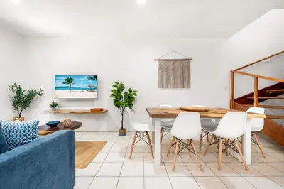 a living room with a table and chairs at PdM6 Newly Renovated Townhome Steps to the Beach in Tamarindo